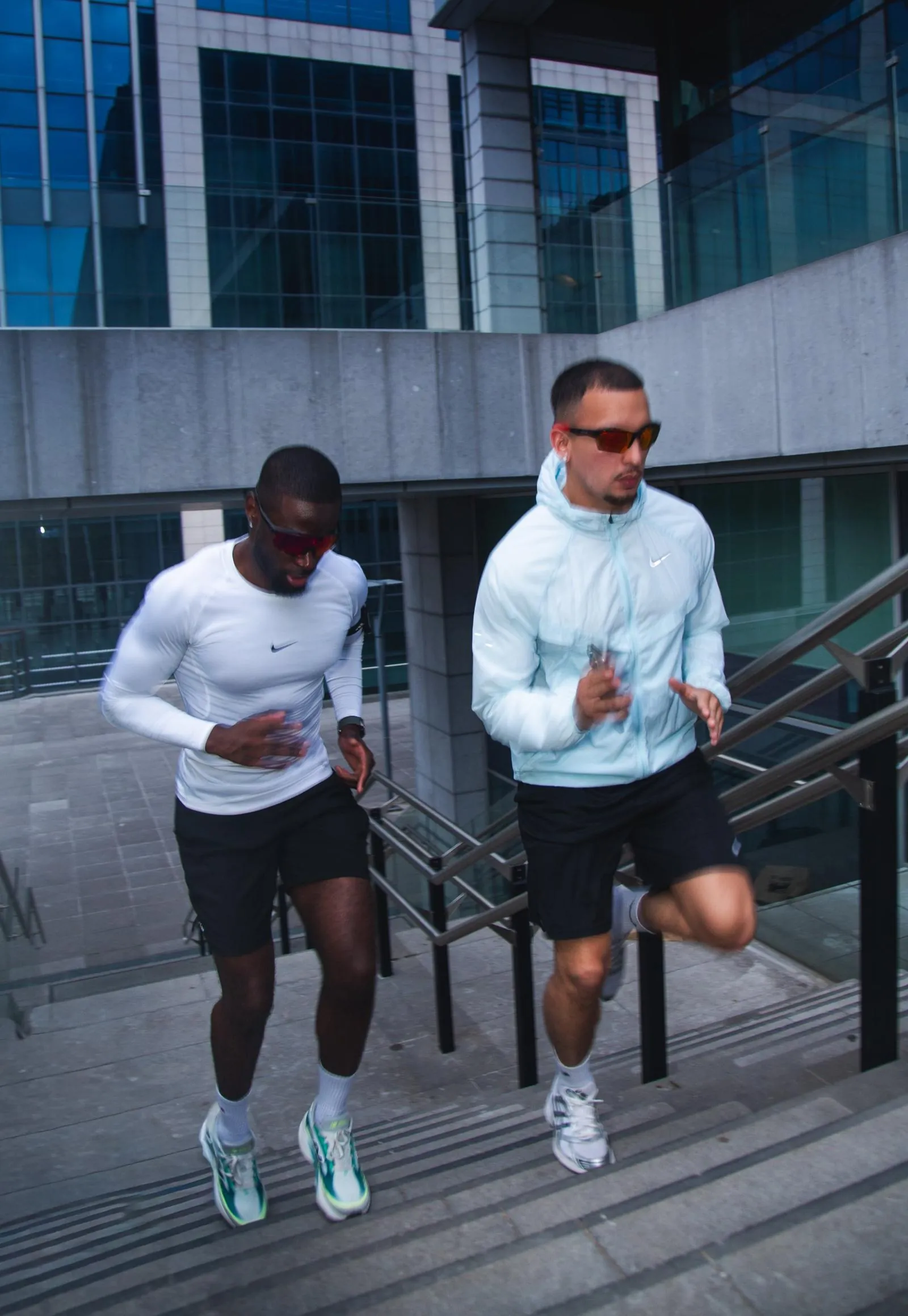 Two runners sprinting up a staircase