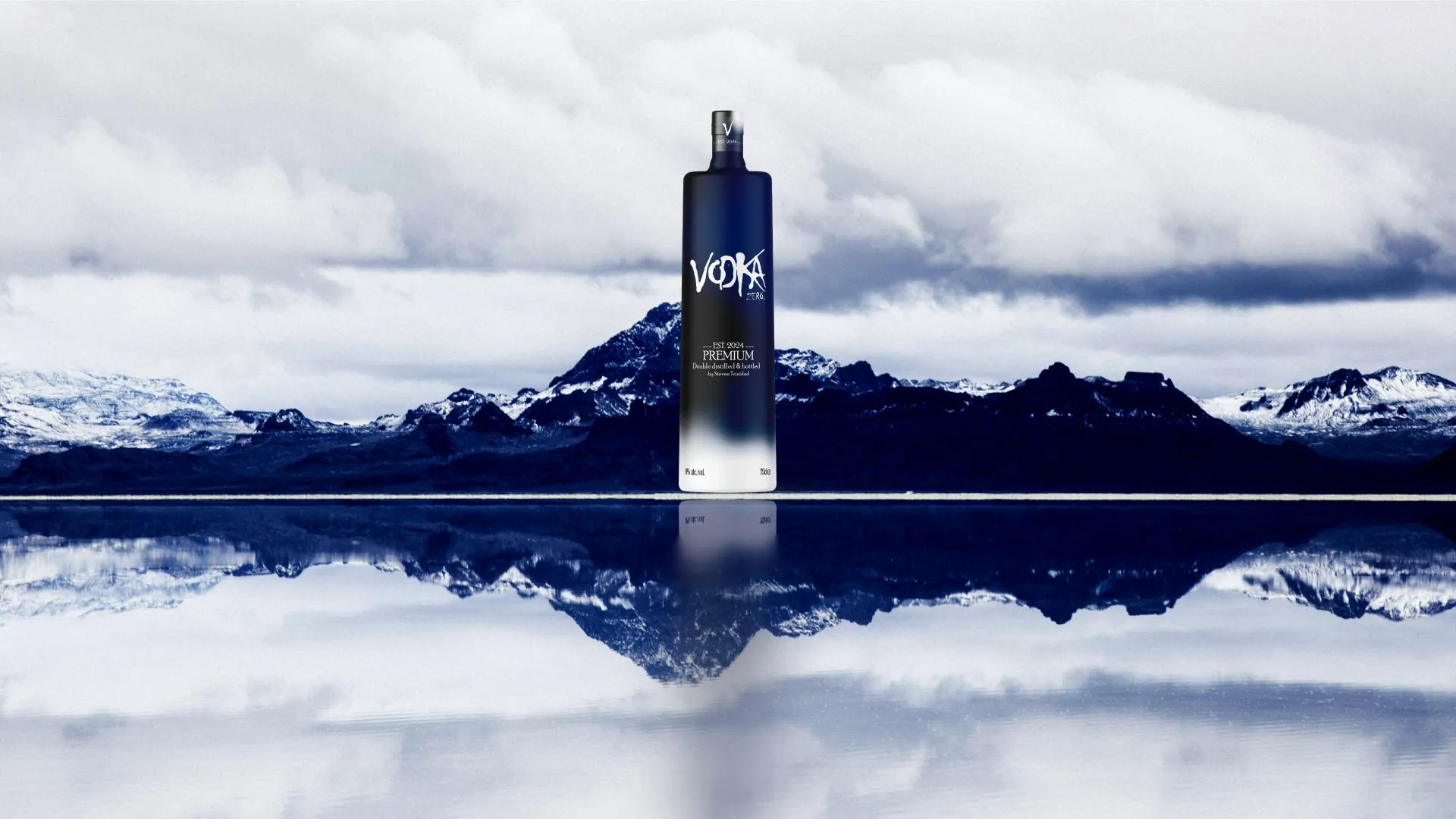 Vodka Zero bottle in front of snowy mountains reflected in a lake